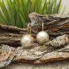 Дамски обеци от 14 каратово злато и украсени от нежността на бялата речна перла